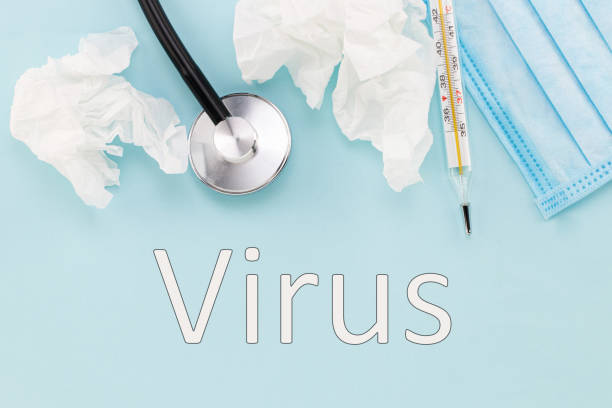 istock virus - text and medical mask, thermometer, stethoscope on a blue background. Virus concept 1346026553