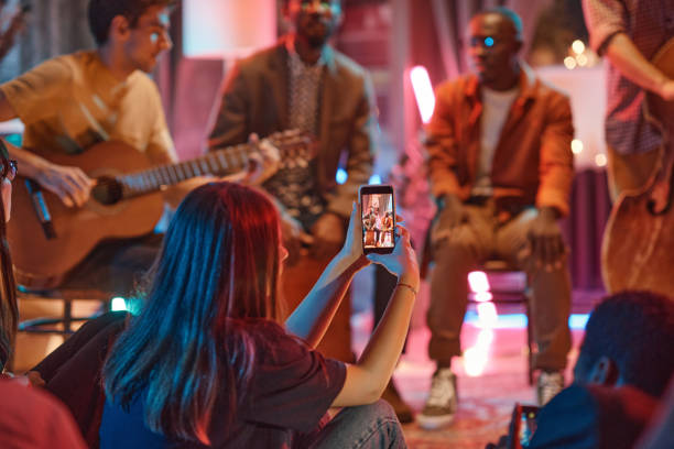 Woman shooting the performance on her phone