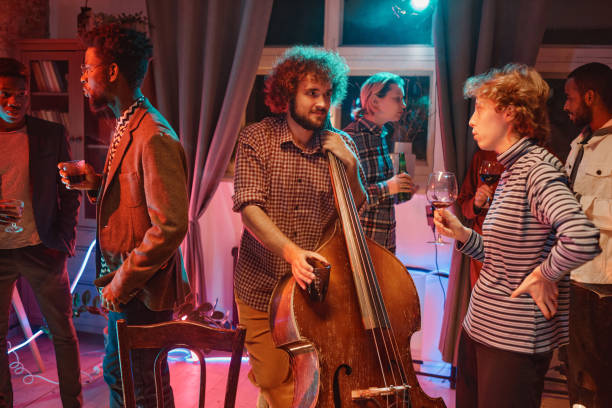 istock People visiting party with musician 1346028006