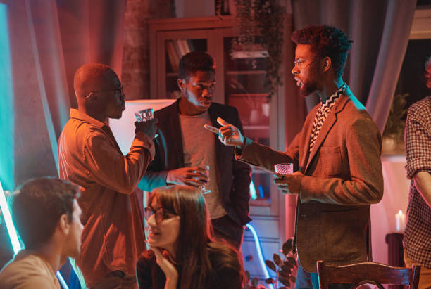 African men visiting social event African young men having a meeting at social event they talking to each other and drinking alcohol black people bar stock pictures, royalty-free photos & images
