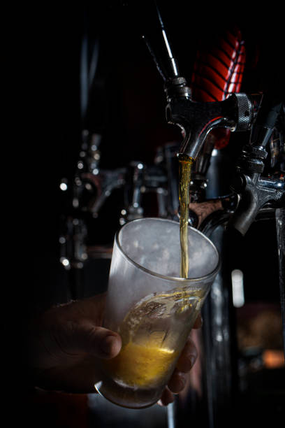 istock Pouring a Beer Pint at Bar Taps 1346029290