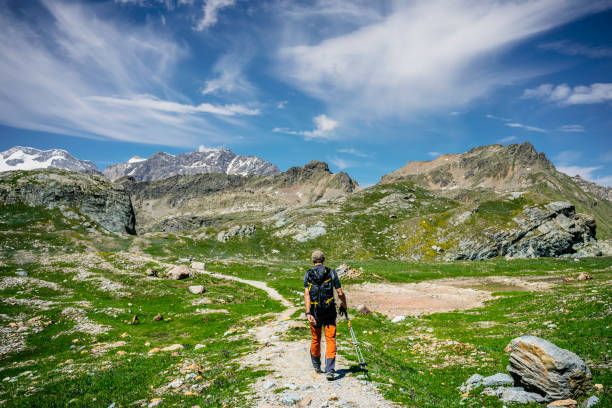 istock Lonely hiker walking along high mountain trail 1346029309
