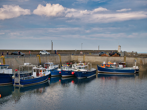 Several fishing boats moored in the harbour at Seahouses on the Northumberland coast in the north east of England, UK