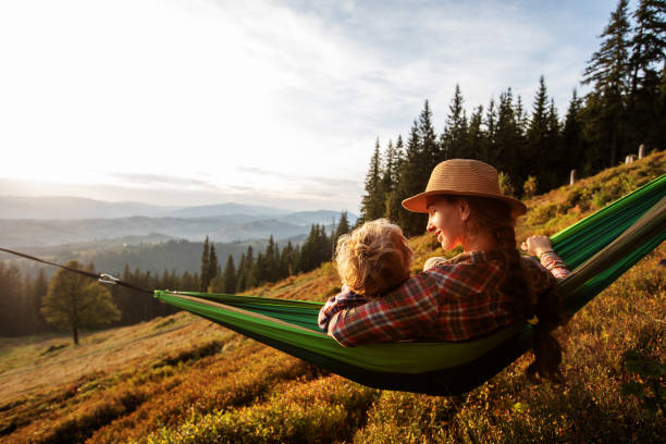 istock Boy tourist resting in a hammock in the mountains at sunset 1346029805