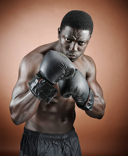 Defence position Muscular serious looking boxer training fighting stance stock pictures, royalty-free photos & images