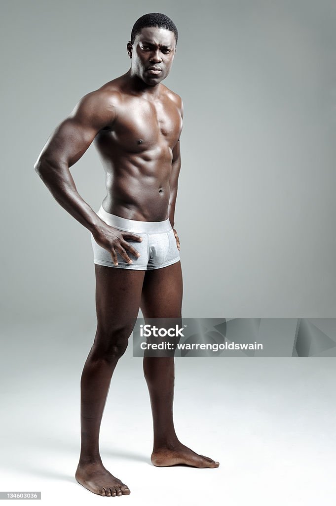 Attractive buff man in studio Sexy black model striking a pose in the studio Men Stock Photo