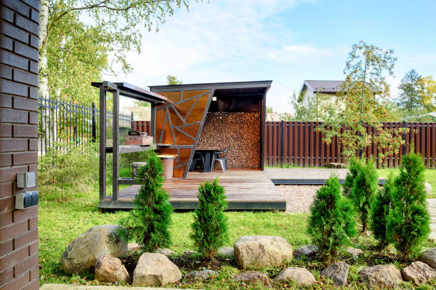 istock Picnic area with barbecue grill and table and chairs 1346031082