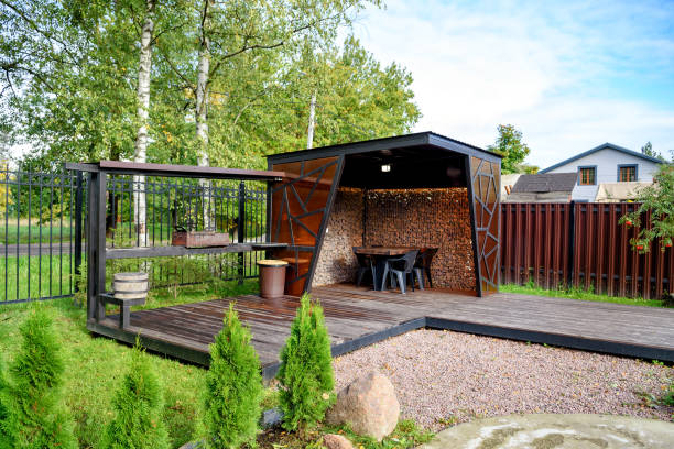 istock Picnic area with barbecue grill and table and chairs 1346031092