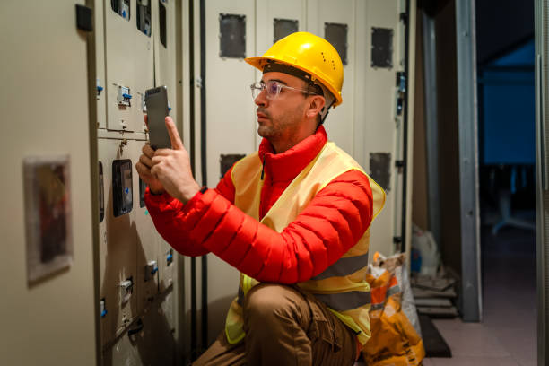 istock Electrician repairing circuit breakers in industrial electric panel 1346031478
