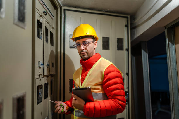 istock Electrician repairing circuit breakers in industrial electric panel 1346032743
