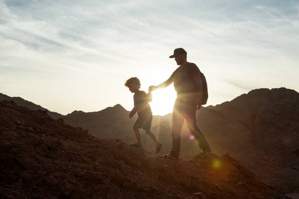 istock Dad with son in the mountains in the desert 1346033749