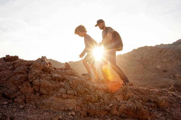 istock Dad with son in the mountains in the desert 1346033751
