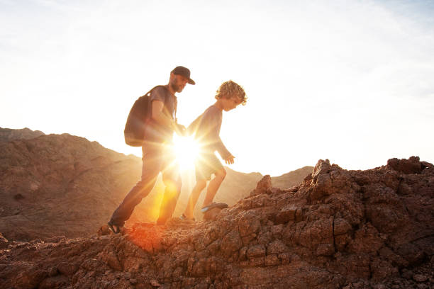 istock Dad with son in the mountains in the desert 1346033752