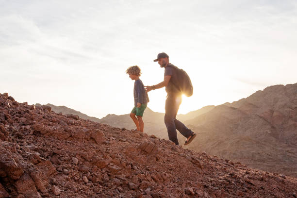 istock Dad with son in the mountains in the desert 1346033753