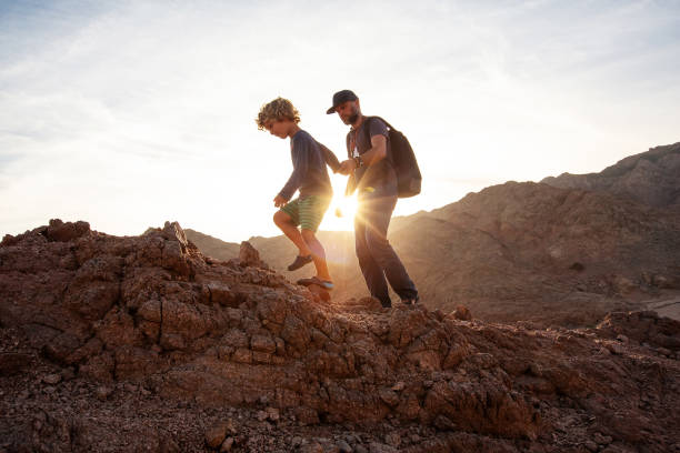 istock Dad with son in the mountains in the desert 1346033756