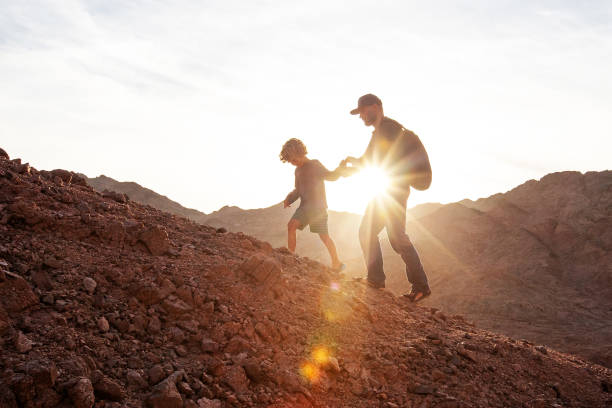 istock Dad with son in the mountains in the desert 1346033759