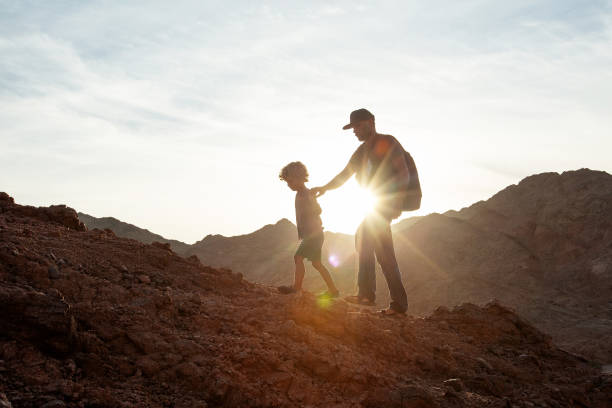 istock Dad with son in the mountains in the desert 1346033763