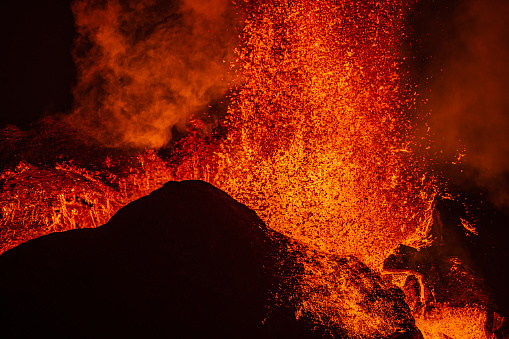 Lava shoots up as it erupts from the crater of the volcanic eruption in Iceland. Details from the crater of the Fagradalsfjall volcano. Volcano on the Reykjanes peninsula in the GeoPark