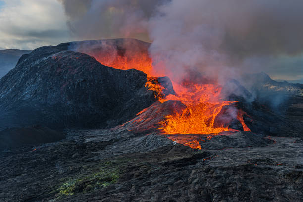 istock Volcanic eruption with lava flow in Iceland 1346035484