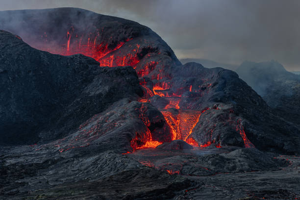 istock Volcanic eruption with lava flow during the day in Iceland 1346035581