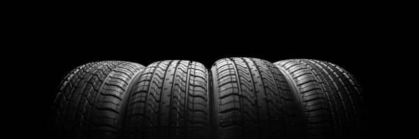 istock black isolation rubber tire, on the black backgrounds 1346037938