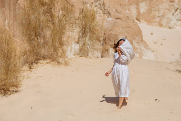 istock Beautiful woman resting in the desert 1346038849