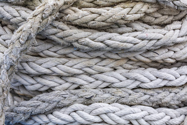 istock Thick twisted gray ship's mooring rope close up 1346038995