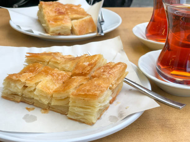 istock Sliced ​​phyllo pastry and Turkish tea on the table 1346039106