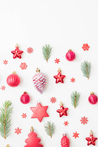 istock Flat lay pattern with fir branches, christmas balls and decorations on a white background 1346039389