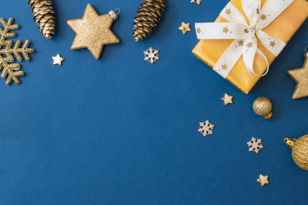 istock Christmas holiday composition. Flat lay frame with christmas balls and gift box on a blue background 1346039405