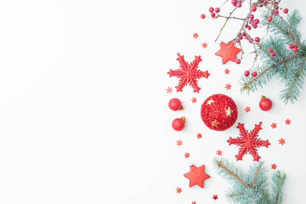 istock Flat lay christmas frame with red berries, fir branches, snowflakes and red balls on a white background. Merry christmas card and copy space for your text 1346039430