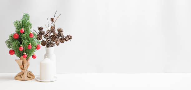 istock Christmas, New Year home decor. Christmas tree on a light background. Mock up for displaying works 1346039464
