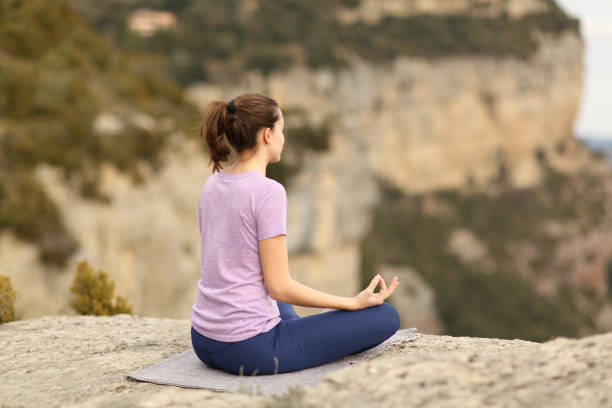 istock Woman alone doing yoga in a cliff 1346039660
