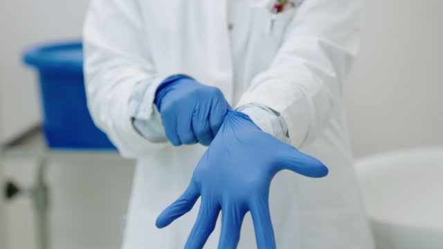 Close-up of a female medical professional wearing protective gloves