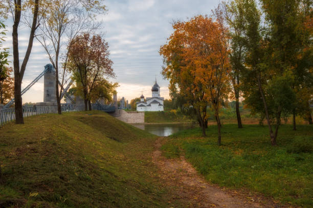 City Ostrov  with the famous ancient chain bridges and the Temple on the island in golden autumn time City Ostrov  with the famous ancient chain bridges and the Temple on the island in golden autumn time pskov city stock pictures, royalty-free photos & images
