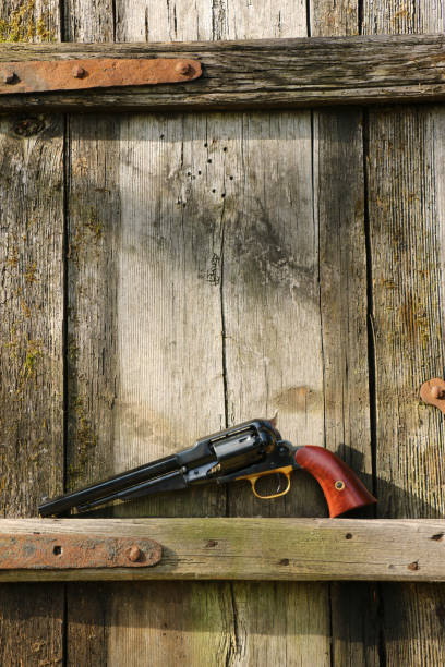 istock Black powder revolver on an old board. 1346041070