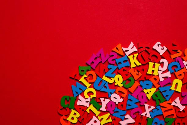 istock Random colorful alphabet on a red background, colorful letters. 1346042193