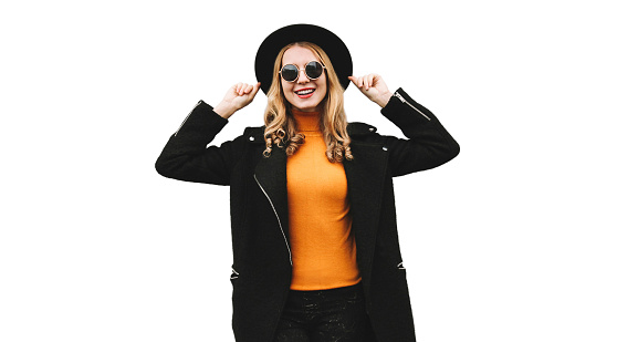 Stylish cheerful smiling young woman having fun model posing wearing a black coat, round hat isolated on a white background