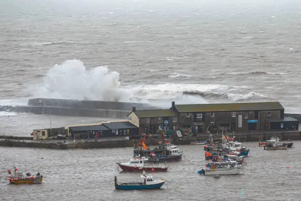 Photo of waves Braking over harbour wall