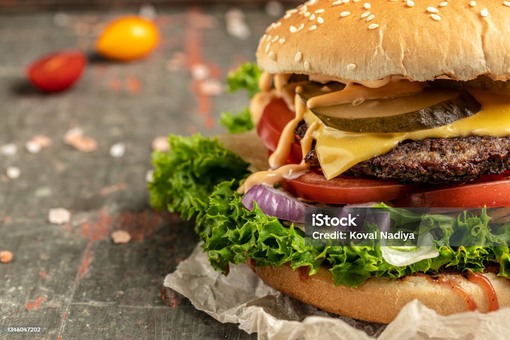 Home made hamburger with beef, lettuce and cheese, American food. fast food, banner, menu, recipe place for text Home made hamburger with beef, lettuce and cheese, American food. fast food, banner, menu, recipe place for text, Burger Stock Photo