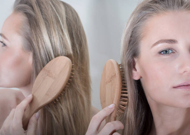 istock Beautiful Woman Combing Hair 1346047462