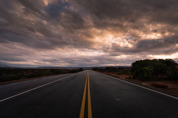 istock Long road in the middle of nowhere under dramatic sunrise sky 1346047706