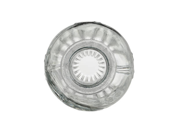 istock Empty, transparent glass bottle with a pattern. Isolated on a white background, close-up, top view 1346047780