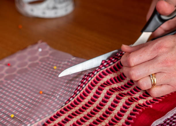 istock Seamstress cutting up colorful fabric 1346049776