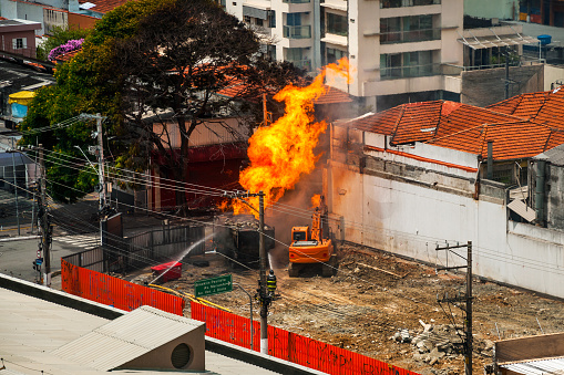 Firefighters fighting a fire caused by a gas leak in a street of Sao Paulo. The city famous for its cultural and business vocation in Brazil.