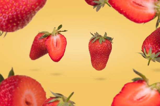 istock Creative composition with floating levitating ripe strawberries on a yellow background. Vitamins, fresh healthy food concept. 1346051420
