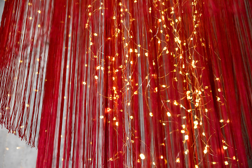 Red Christmas ball surrounded by lights