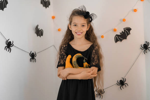 istock Little girl dressed as a witch for Halloween with pumpkin 1346053541