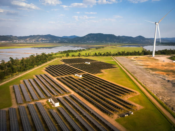 large solar energy farm and windmill - solar panel solar power station sun solar energy imagens e fotografias de stock