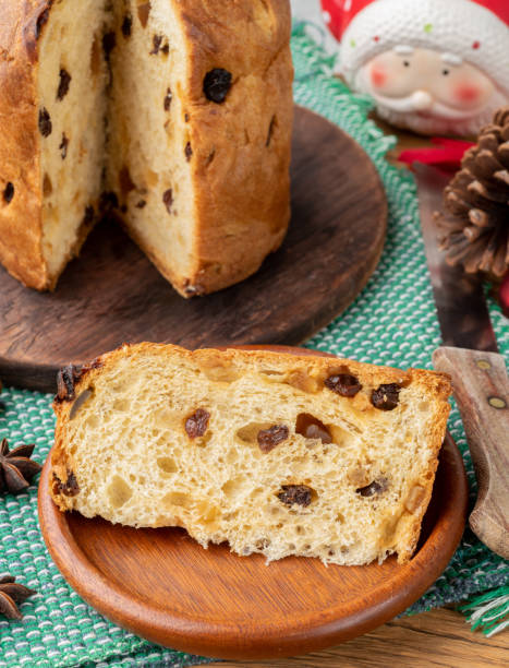 istock Traditional italian christmas fruit cake panettone with slice on a plate 1346056155
